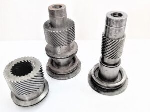 A display of several complex metal parts machined with high precision by the PH46-750 CNC Rotor Whirling Machine These parts feature a high surface finish and intricate details, highlighting the machine's advanced manufacturing capabilities