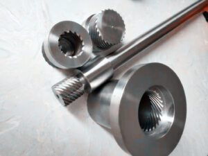 A display of several complex metal parts machined with high precision by the PH46-750 CNC Rotor Whirling Machine These parts feature a high surface finish and intricate details, highlighting the machine's advanced manufacturing capabilities