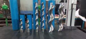 A collection of polished stainless steel helical rotors for progressive cavity pumps, showcasing varied pitches and diameters achieved via CNC thread milling.