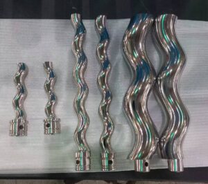 A collection of polished stainless steel helical rotors for progressive cavity pumps, showcasing varied pitches and diameters achieved via CNC thread milling.