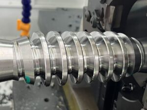 Detailed view of polished, high-precision metal rotor threads recently manufactured by the PH80 series Rotor Whirling Machine.