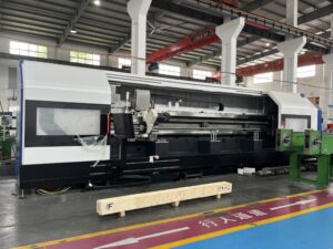 A full-view photograph of a massive industrial thread whirling machine operating on a factory floor, actively milling a large screw workpiece with sparks visible.