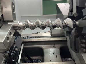 High-efficiency rotor milling on a CNC lathe using a dedicated tool post for complex geometry progressive cavity pump components.